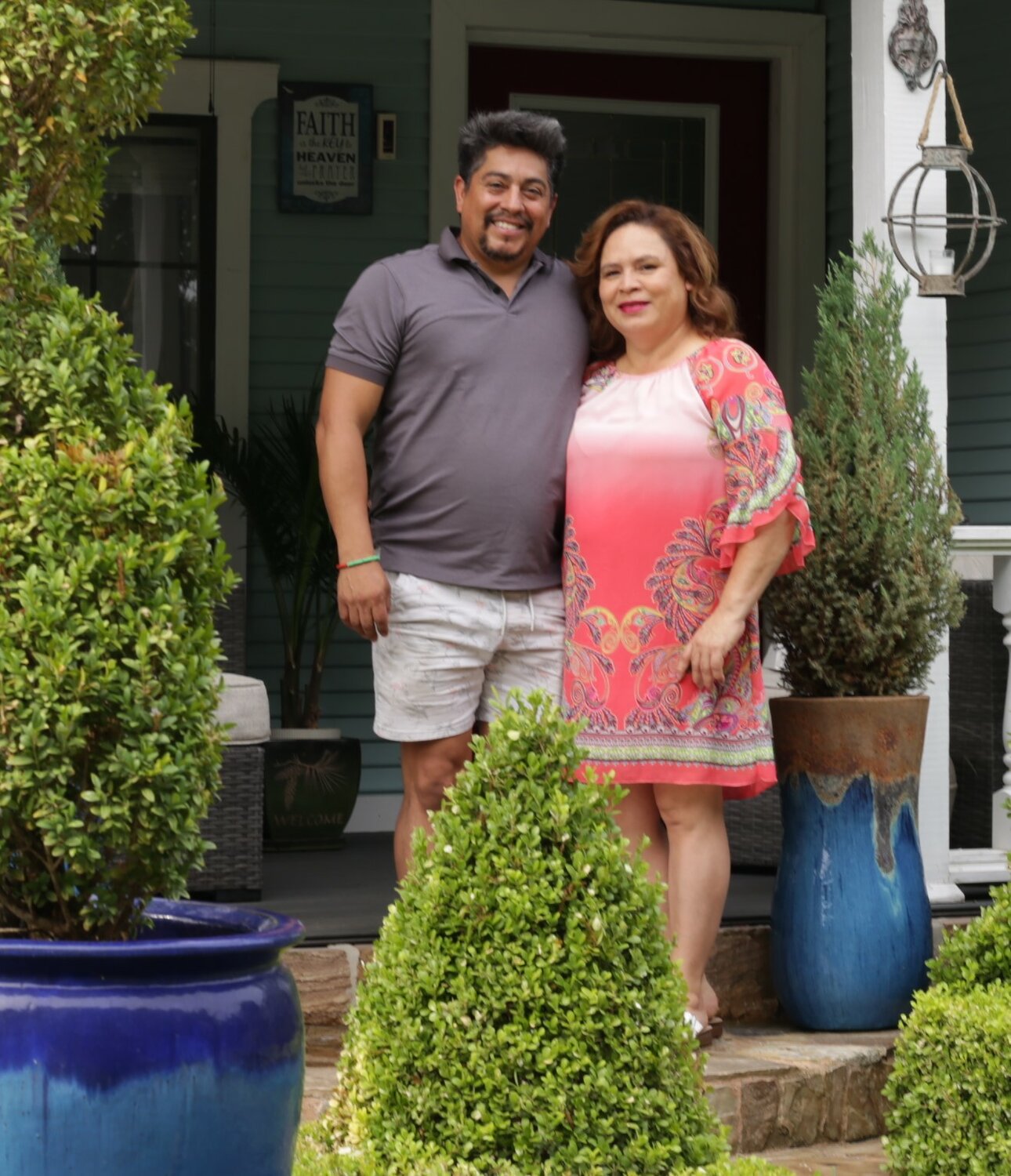 Luis Galaz and Mina Marquez on their Walnut Street front porch during the annual garden tour put on by the Fannie Marchman Garden Club in Mineola. See story, more photos on Page 10A.